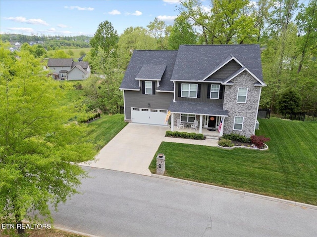 107 Mistletoeberry Rd, Oak Ridge, TN 37830 - view of front of home featuring a porch, a front lawn, a garage, driveway, and stone siding