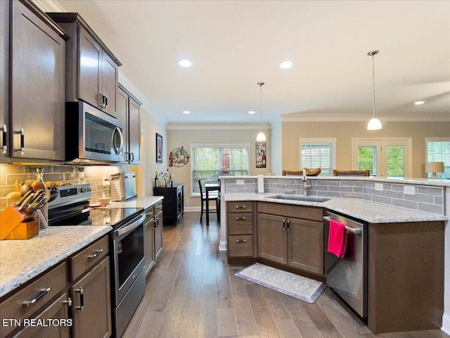 107 Mistletoeberry Rd, Oak Ridge, TN 37830 - kitchen with a sink, stainless steel appliances, decorative backsplash, ornamental molding, and wood finished floors
