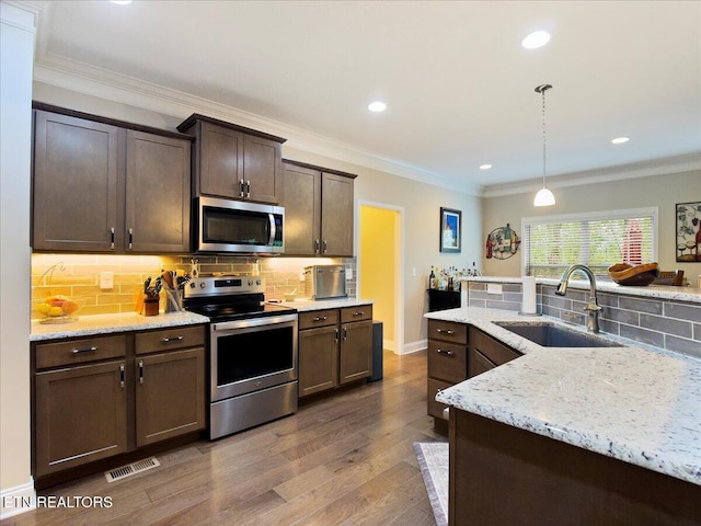 107 Mistletoeberry Rd, Oak Ridge, TN 37830 - kitchen featuring light stone countertops, a sink, stainless steel appliances, tasteful backsplash, and visible vents