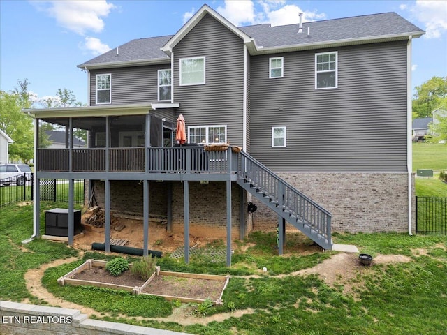 107 Mistletoeberry Rd, Oak Ridge, TN 37830 - rear view of house with a garden, fence, stairs, a sunroom, and a lawn