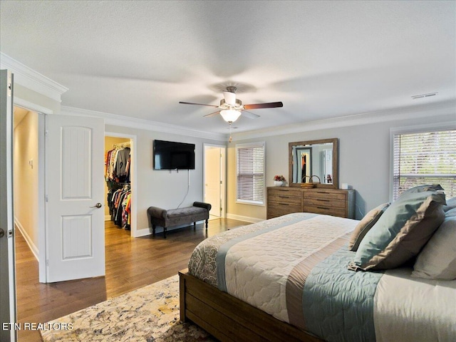 107 Mistletoeberry Rd, Oak Ridge, TN 37830 - bedroom with ceiling fan, crown molding, visible vents, wood finished floors, and a spacious closet
