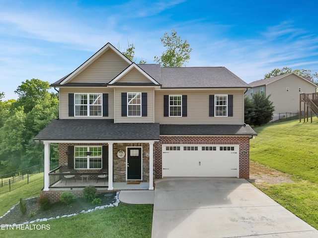 view of front of property featuring a garage, fence, a front yard, concrete driveway, and a porch