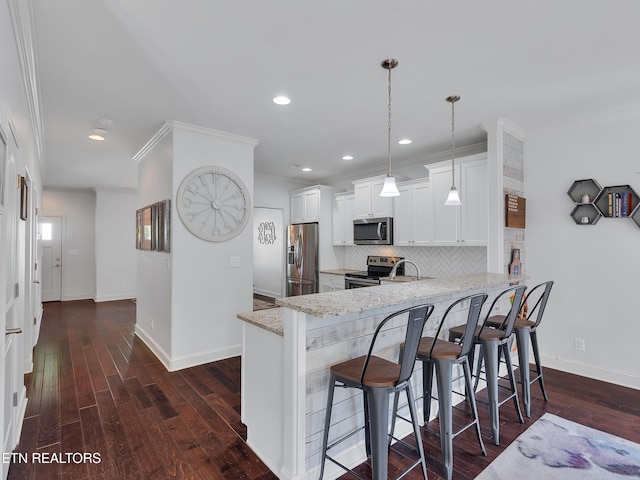 kitchen featuring decorative backsplash, a peninsula, baseboards, light stone counters, and appliances with stainless steel finishes