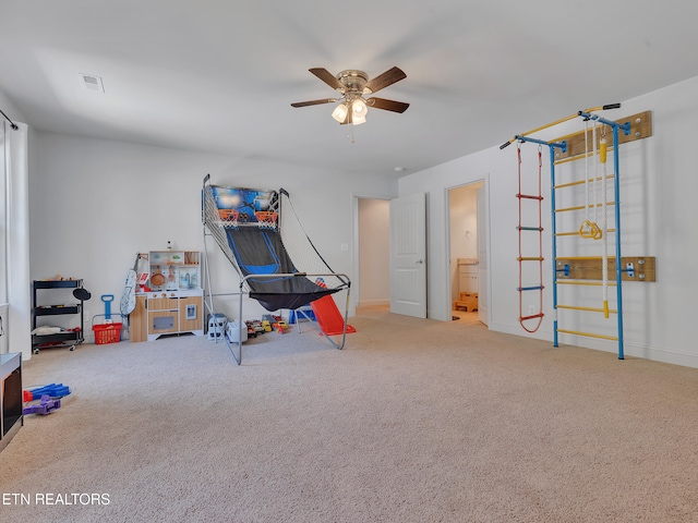 rec room with carpet floors, baseboards, and a ceiling fan
