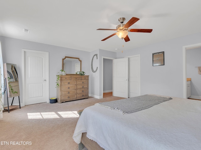 bedroom with baseboards, ceiling fan, visible vents, and light colored carpet