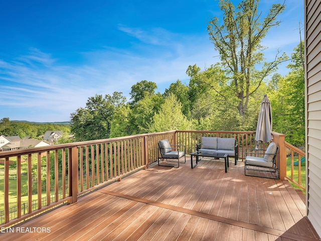 wooden terrace with an outdoor hangout area