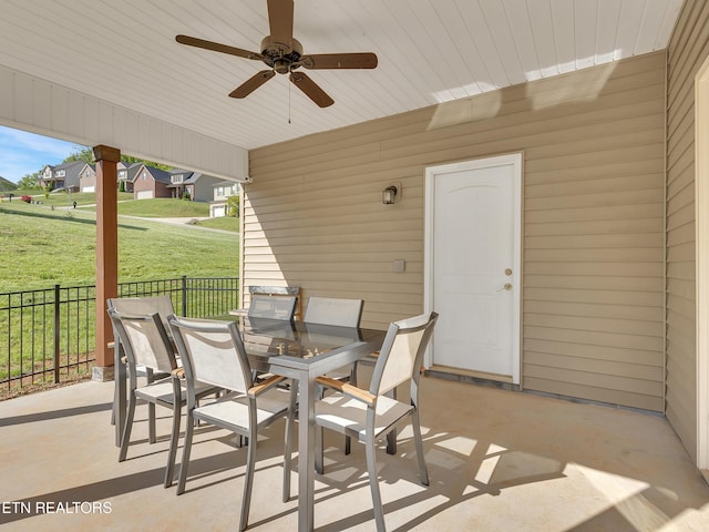 view of patio featuring fence, a ceiling fan, and outdoor dining space