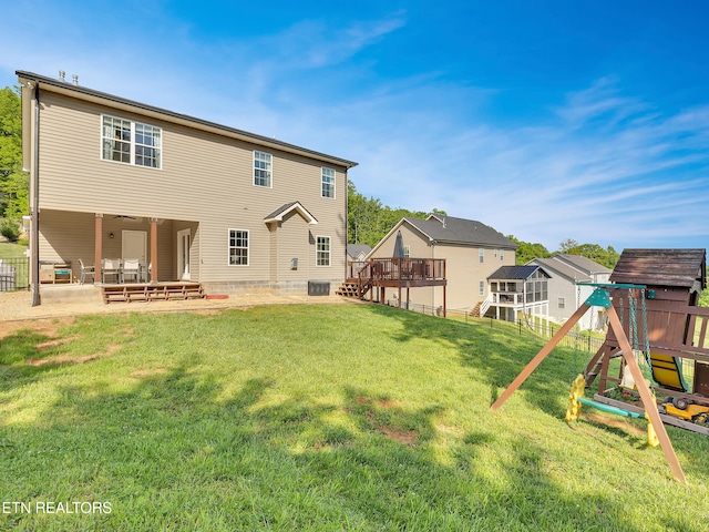 rear view of house with a fenced backyard, cooling unit, a playground, a patio, and a yard