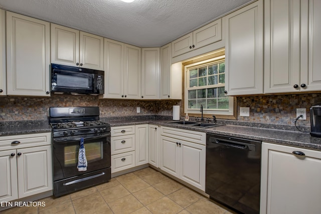 kitchen with a sink, light tile patterned floors, black appliances, and dark countertops