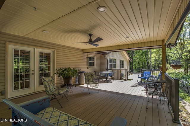 deck featuring ceiling fan, french doors, and outdoor dining space