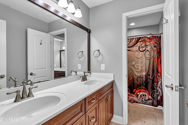 full bath featuring tile patterned floors, double vanity, and a sink
