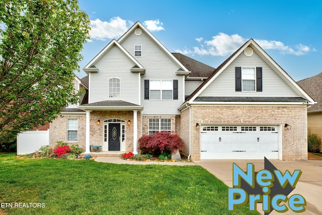 2630 Nicholas View Ln, Knoxville, TN 37931 - traditional-style house with concrete driveway, a front yard, brick siding, a garage, and roof with shingles