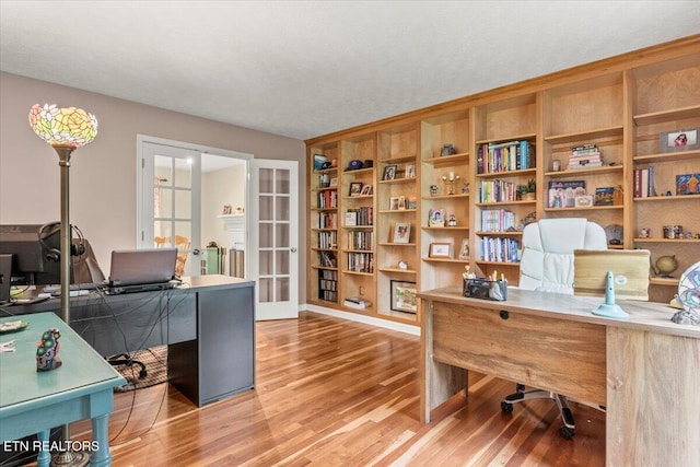office featuring french doors and wood finished floors