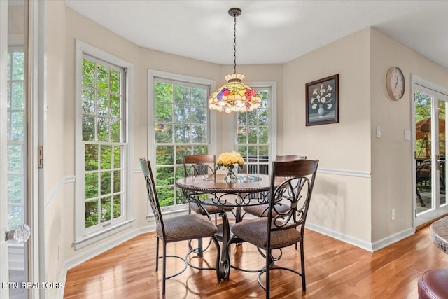 dining area featuring baseboards and light wood-style floors