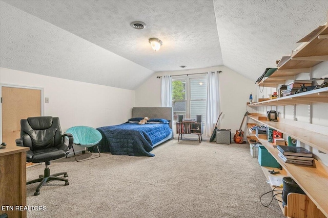 bedroom with lofted ceiling, a textured ceiling, visible vents, and carpet flooring