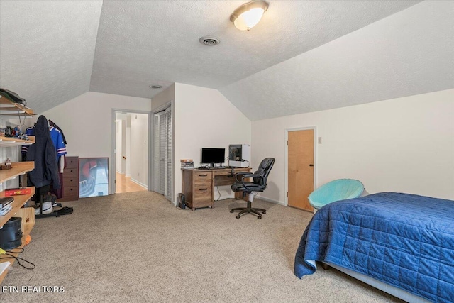 bedroom featuring carpet flooring, a textured ceiling, visible vents, and vaulted ceiling