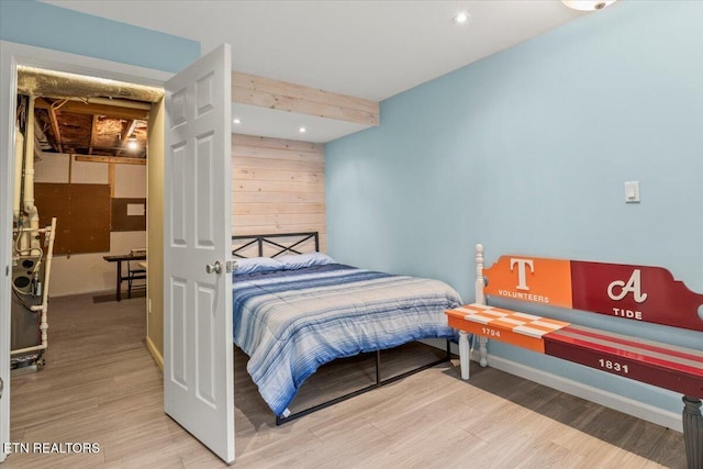 bedroom featuring wood finished floors, recessed lighting, and baseboards