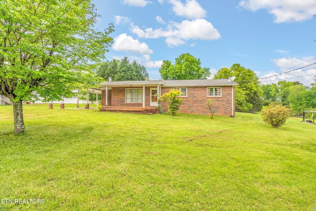 ranch-style home featuring brick siding and a front lawn