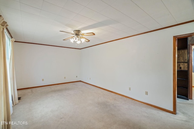 unfurnished bedroom featuring baseboards, ornamental molding, and light colored carpet