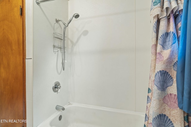 bathroom with shower / bath combo with shower curtain