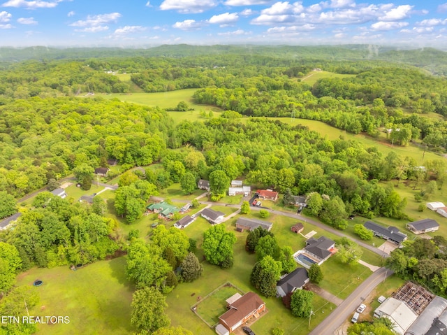 drone / aerial view featuring a view of trees
