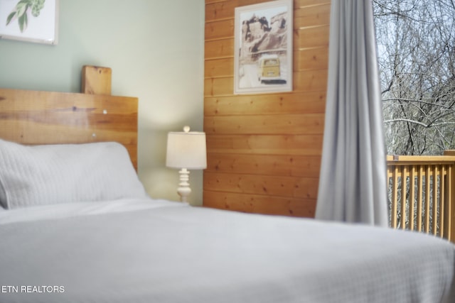 bedroom with wooden walls