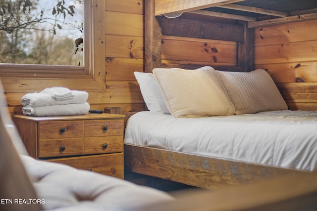 bedroom with wood walls