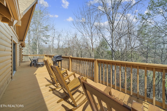 wooden terrace with outdoor dining area