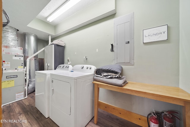 clothes washing area with washer and dryer, laundry area, dark wood-style floors, and electric panel
