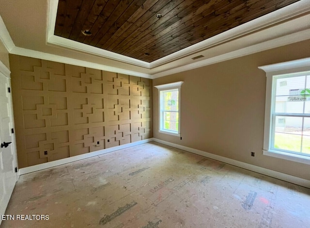 empty room with ornamental molding, wooden ceiling, baseboards, and a tray ceiling