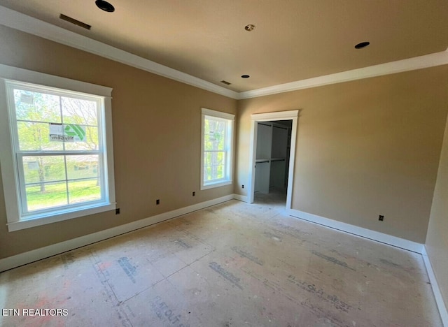 unfurnished bedroom featuring baseboards, ornamental molding, and multiple windows