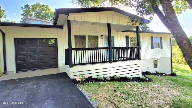 1805 Ferd Hickey Rd, Knoxville, TN 37909 - view of front facade featuring an attached garage, covered porch, a front lawn, and aphalt driveway