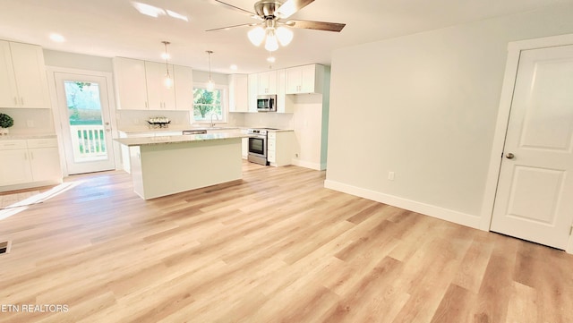 1805 Ferd Hickey Rd, Knoxville, TN 37909 - kitchen with light wood finished floors, a center island, white cabinets, appliances with stainless steel finishes, and recessed lighting