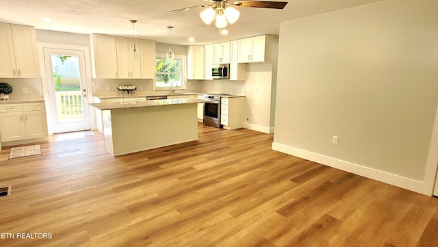 1805 Ferd Hickey Rd, Knoxville, TN 37909 - kitchen featuring a ceiling fan, a sink, baseboards, appliances with stainless steel finishes, and decorative backsplash