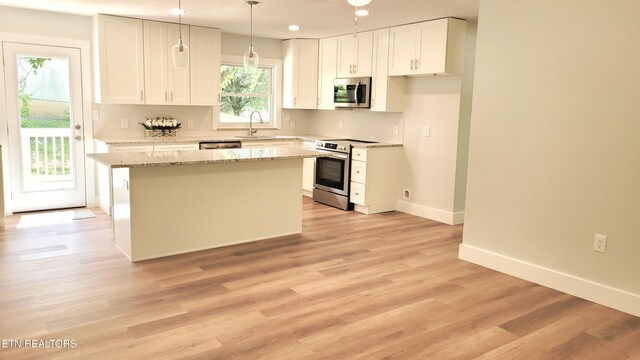 1805 Ferd Hickey Rd, Knoxville, TN 37909 - kitchen featuring a sink, white cabinetry, a kitchen island, tasteful backsplash, and appliances with stainless steel finishes