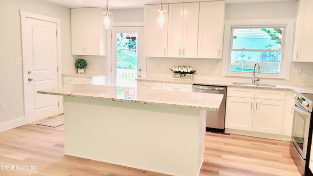 1805 Ferd Hickey Rd, Knoxville, TN 37909 - kitchen featuring a center island, a sink, white cabinetry, light wood-style floors, and appliances with stainless steel finishes
