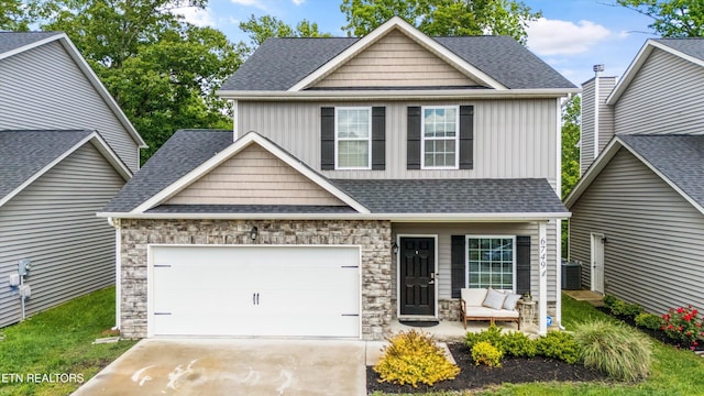6749 Albatross Ln, Knoxville, TN 37921 - view of front of property with driveway, an attached garage, stone siding, a shingled roof, and board and batten siding