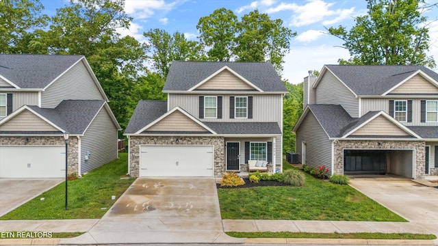 6749 Albatross Ln, Knoxville, TN 37921 - craftsman-style home featuring stone siding, concrete driveway, central AC unit, and a front lawn