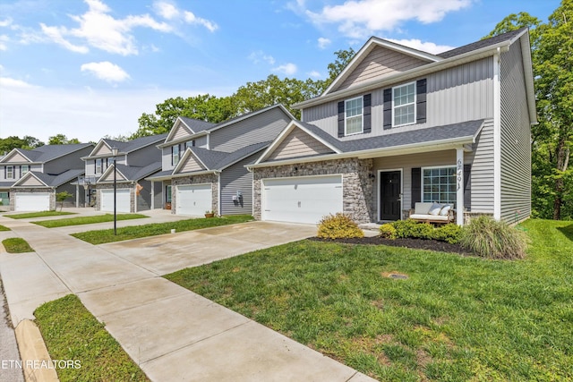 6749 Albatross Ln, Knoxville, TN 37921 - townhome / multi-family property with concrete driveway, a front lawn, an attached garage, and stone siding