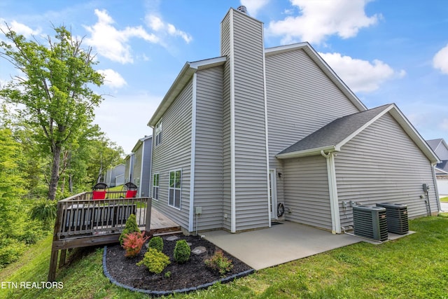 6749 Albatross Ln, Knoxville, TN 37921 - rear view of property featuring a deck, a chimney, a yard, a patio, and cooling unit