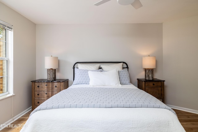 bedroom featuring baseboards, ceiling fan, and wood finished floors