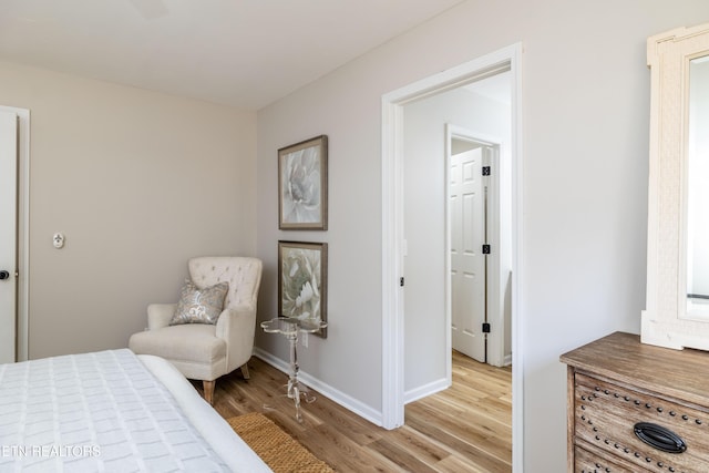 bedroom with baseboards and wood finished floors