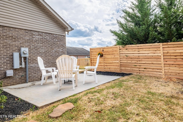 view of yard featuring fence and a patio
