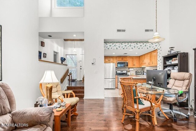 67 Eagle Ct, Crossville, TN 38558 - dining room featuring dark wood-style floors, a high ceiling, and visible vents