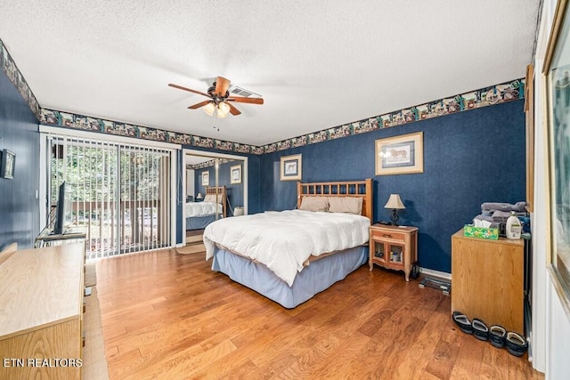 67 Eagle Ct, Crossville, TN 38558 - bedroom with a textured ceiling, ceiling fan, access to exterior, and wood finished floors