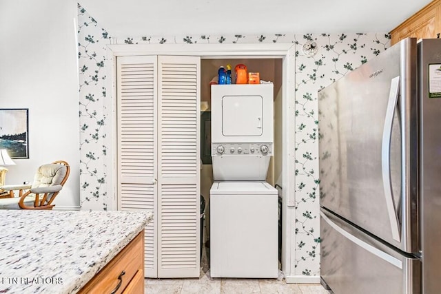 67 Eagle Ct, Crossville, TN 38558 - clothes washing area featuring wallpapered walls, stacked washer and clothes dryer, and laundry area