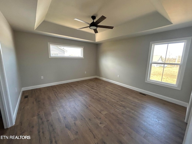 257 Colby Cir, Crossville, TN 38571 - spare room featuring a raised ceiling, ceiling fan, visible vents, baseboards, and dark wood-type flooring
