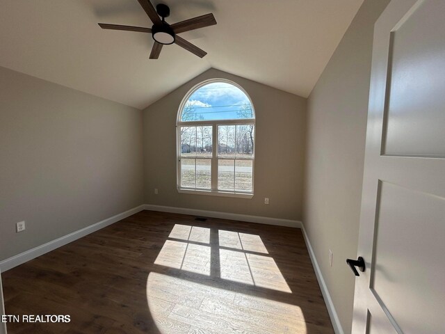 257 Colby Cir, Crossville, TN 38571 - unfurnished room with a ceiling fan, baseboards, vaulted ceiling, and dark wood-type flooring