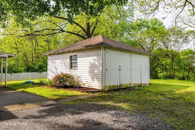 view of shed featuring fence