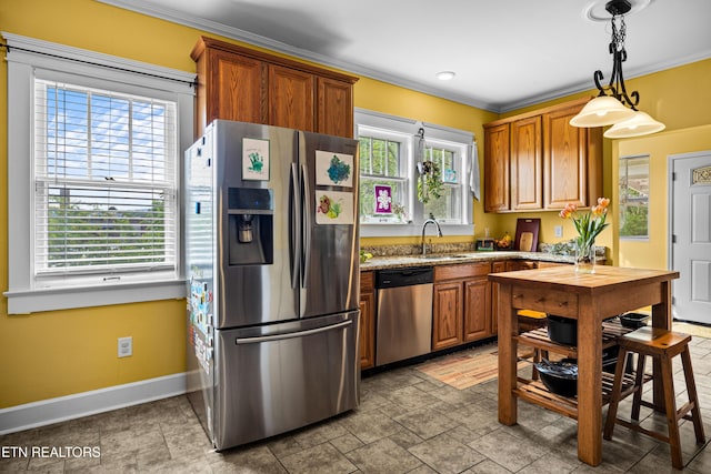 kitchen with stainless steel appliances, baseboards, ornamental molding, and a sink